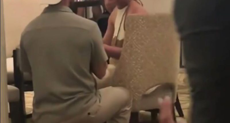 Man proposing to woman in restaurant.