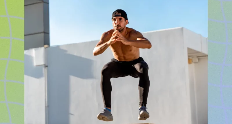 fit man doing squat jumps exercise outdoors