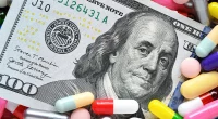 Pills on money dollars - Medicine prescription drugs cost concept - healthcare insurance expenses