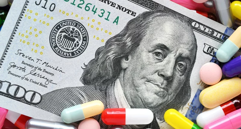 Pills on money dollars - Medicine prescription drugs cost concept - healthcare insurance expenses