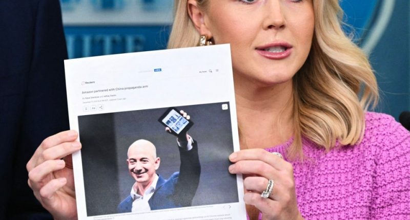 White House Press Secretary Karoline Leavitt holds a news article stating that Amazon partnered with a Chinese propaganda arm.