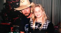 Photo of a father and daughter near a Christmas tree.