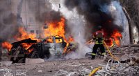 A firefighter extinguishes a fire at the site of a missile attack in Sumy, Ukraine.