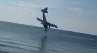 A small plane crashing into the ocean.