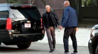 Barack Obama walking with a Secret Service agent.