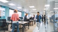 Multiethnic business colleagues walking in a modern office.