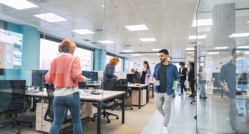 Multiethnic business colleagues walking in a modern office.