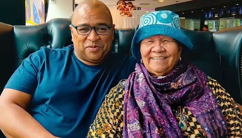 Photo of a son and mother sitting together.