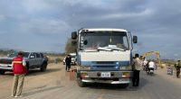A body lies on a road near a truck involved in a fatal accident.