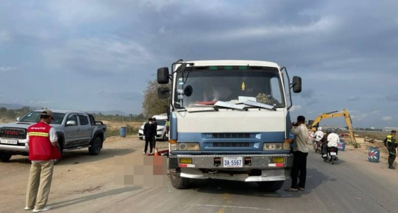 A body lies on a road near a truck involved in a fatal accident.