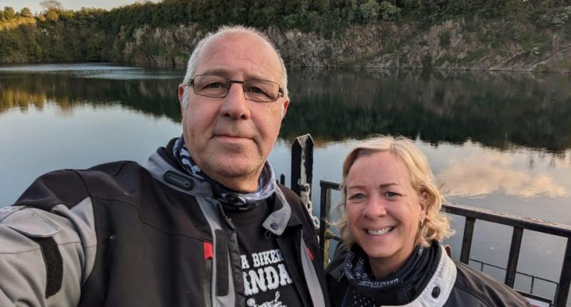Selfie of Elaine and Graeme Winn at a lake.