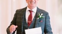 Man in suit giving a speech.