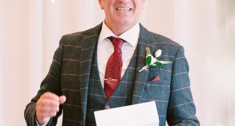 Man in suit giving a speech.