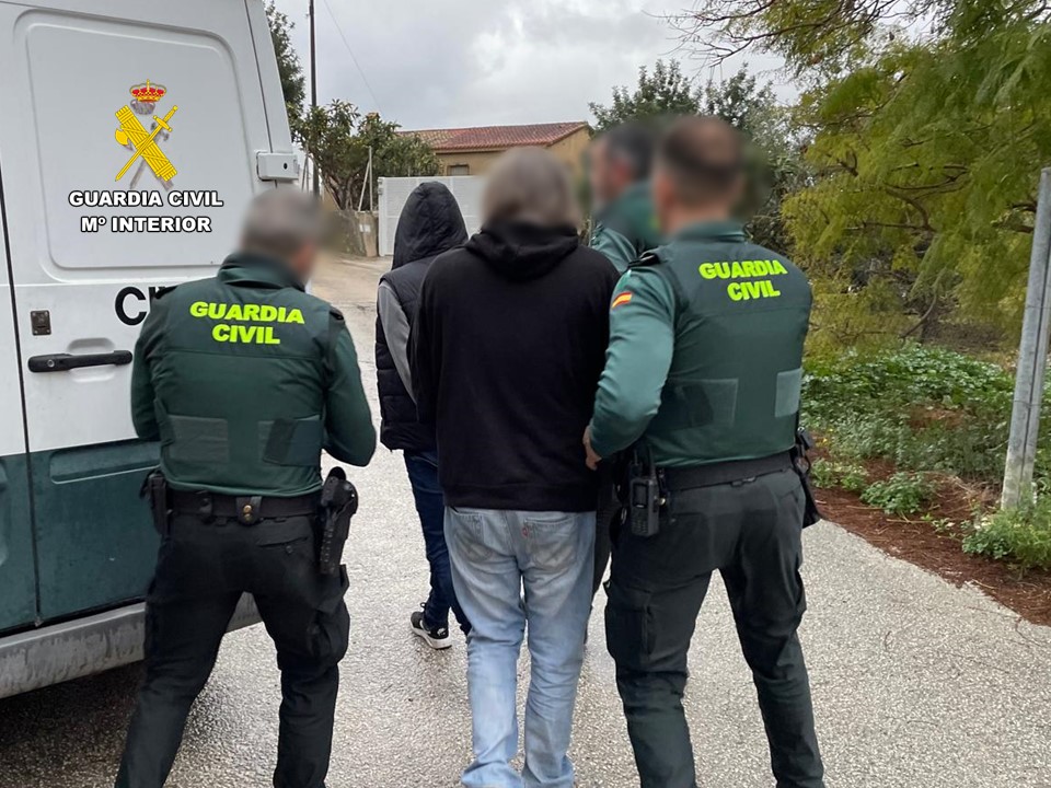 Guardia Civil officers arresting suspects.