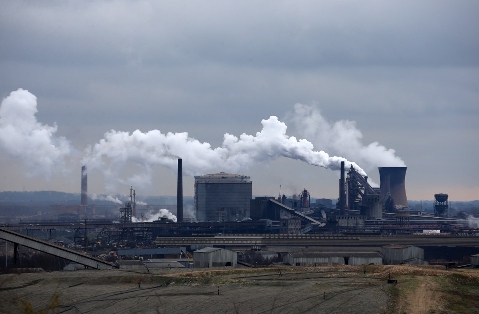 Smoke billowing from a steel plant.