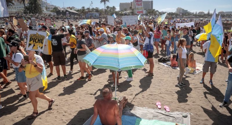 Protest against mass tourism on a beach in Tenerife.