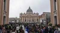 Large crowd of people queueing in St. Peter's Square to pay respects to Pope Francis.