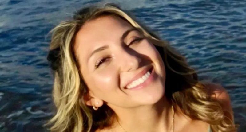 Woman smiling by the ocean.