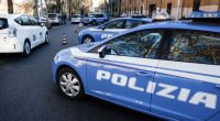 Italian police cars at a security checkpoint.