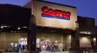 Shoppers entering a Costco Wholesale store at dusk.