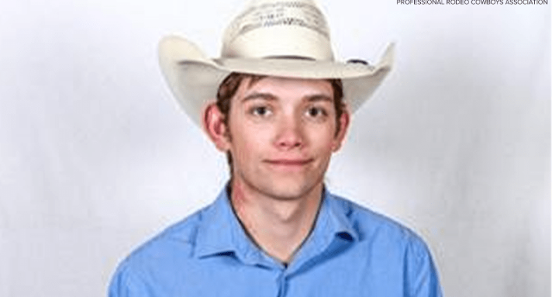 Photo of a young man wearing a cowboy hat and blue shirt.