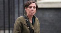 Jess Phillips, UK Parliamentary Under-Secretary of State for Safeguarding and Violence Against Women and Girls, using a mobile phone.