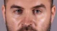 Mugshot of a man with short brown hair and a beard.