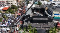Aerial view of rescue workers at the site of a collapsed building.