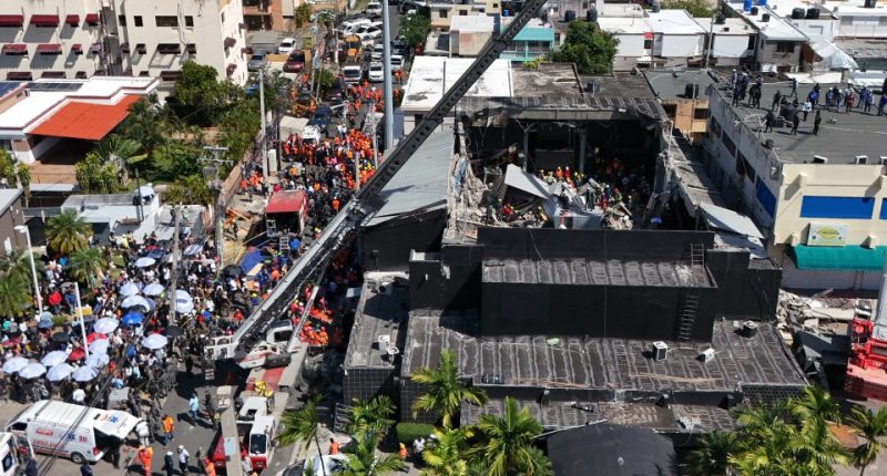 Aerial view of rescue workers at the site of a collapsed building.