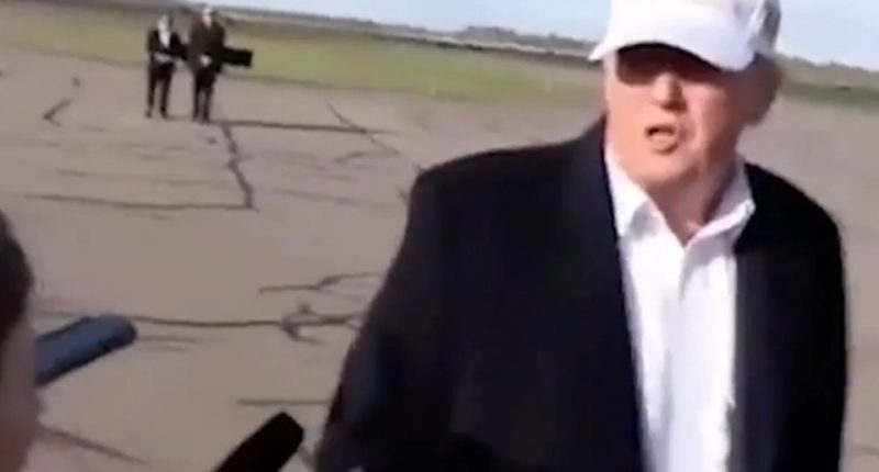 Donald Trump giving an interview on an airfield.