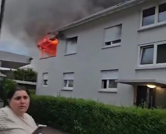 Man escaping burning building by jumping onto a trampoline.