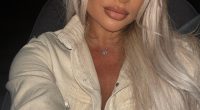 Portrait of a blonde woman wearing a beige jacket.