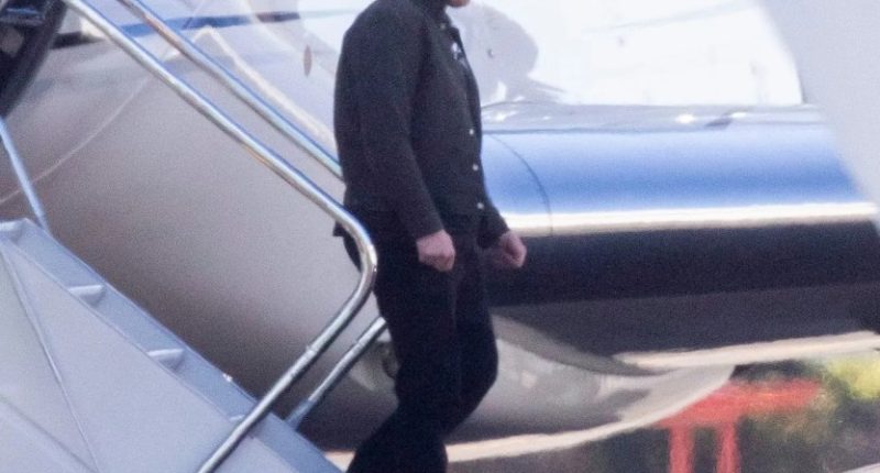 Elon Musk disembarking a private jet.