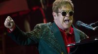 Elton John performing at a concert.