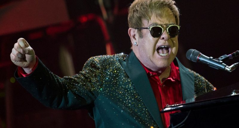 Elton John performing at a concert.