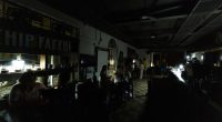 Patrons dining in a dimly lit restaurant during a power outage.