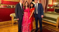 Group photo of four people in formal attire.