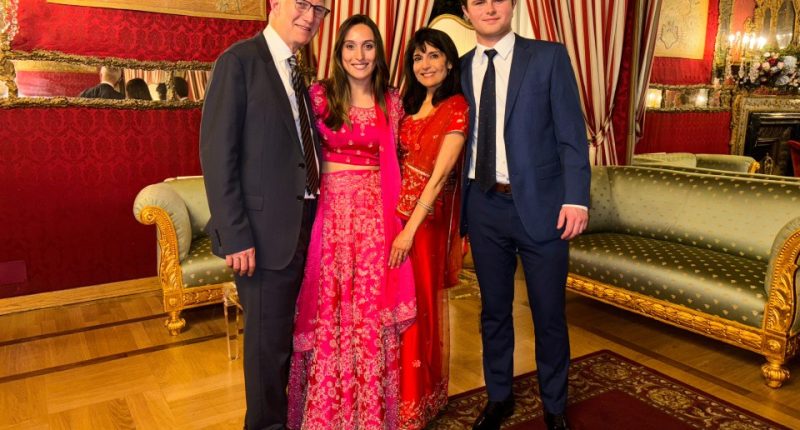 Group photo of four people in formal attire.