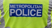 Close-up of a Metropolitan Police officer's back.