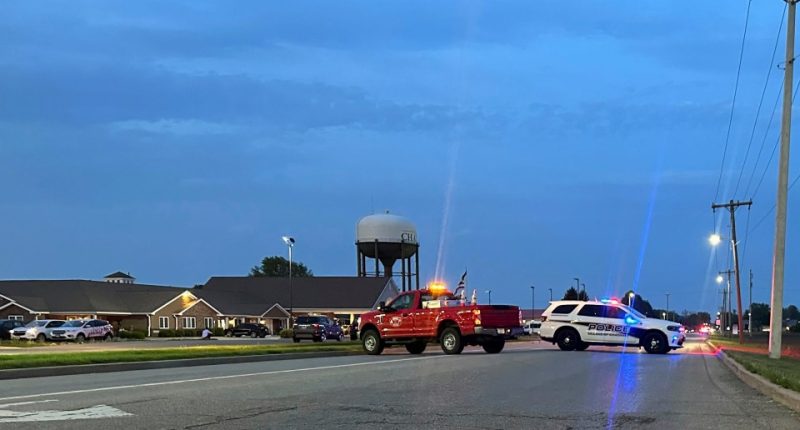 Emergency vehicles blocking a road.