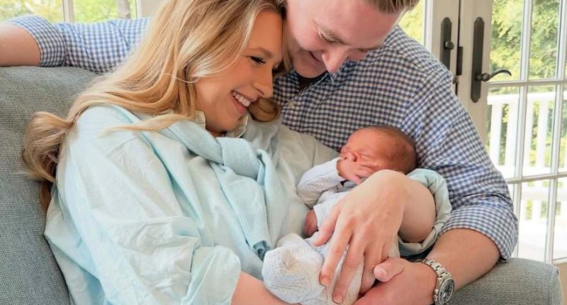 Parents holding their newborn baby.