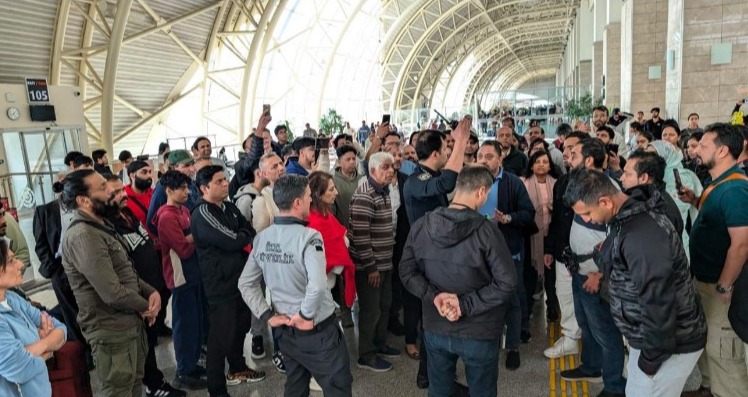 Large group of passengers stranded at an airport.