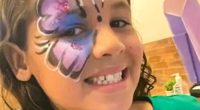 Girl with butterfly face paint.