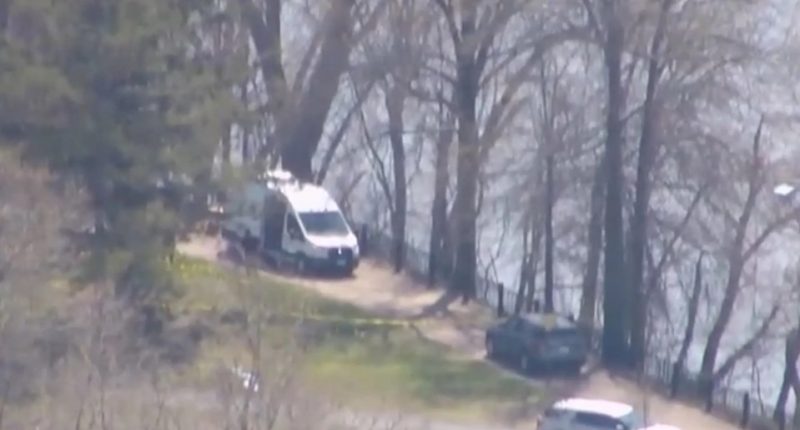 Crime scene with police vehicles.