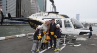 Family posing in front of a helicopter before a fatal crash.