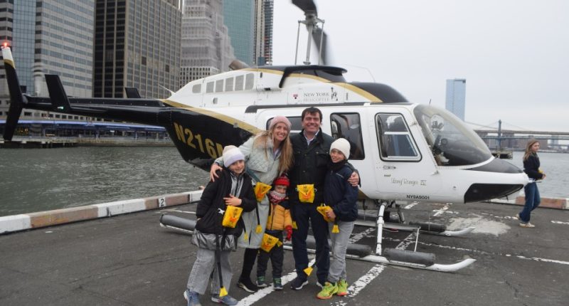 Family posing in front of a helicopter before a fatal crash.