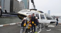 Family posing in front of a helicopter before a fatal crash.