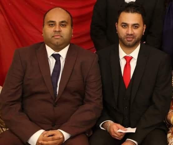 Man in suit standing outdoors.
