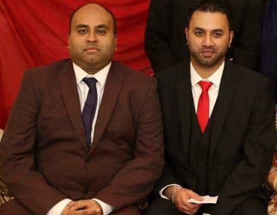 Man in suit standing outdoors.
