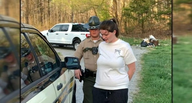 Woman in handcuffs being arrested by a police officer.